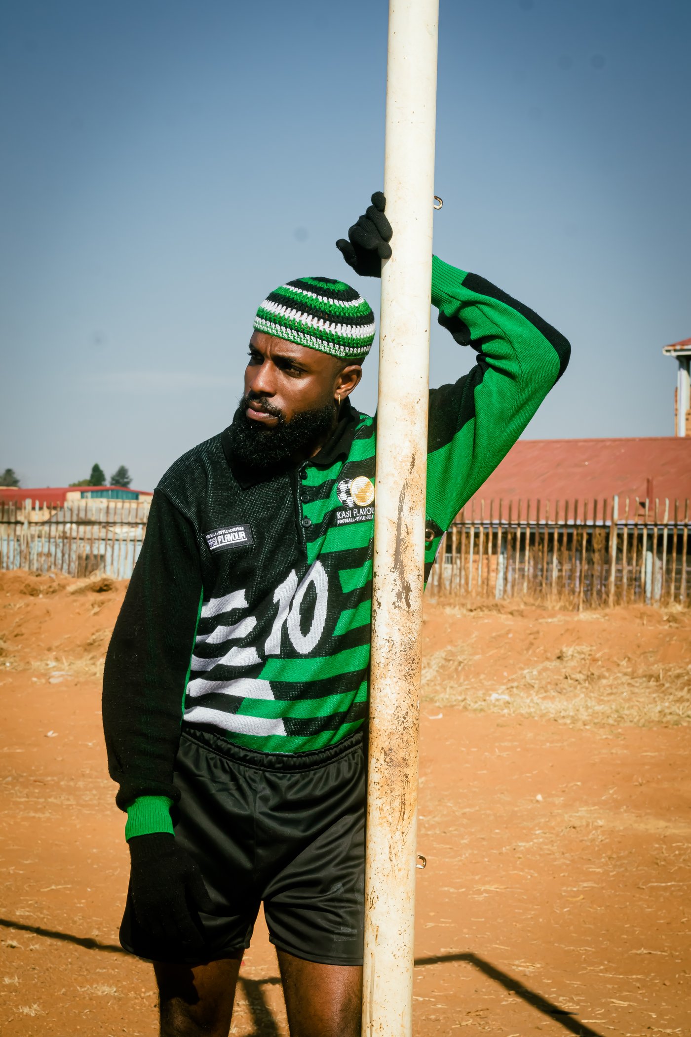 From Daily Click: man in green and black number 10 Kasi Flavour jersey leaning on a goalpost