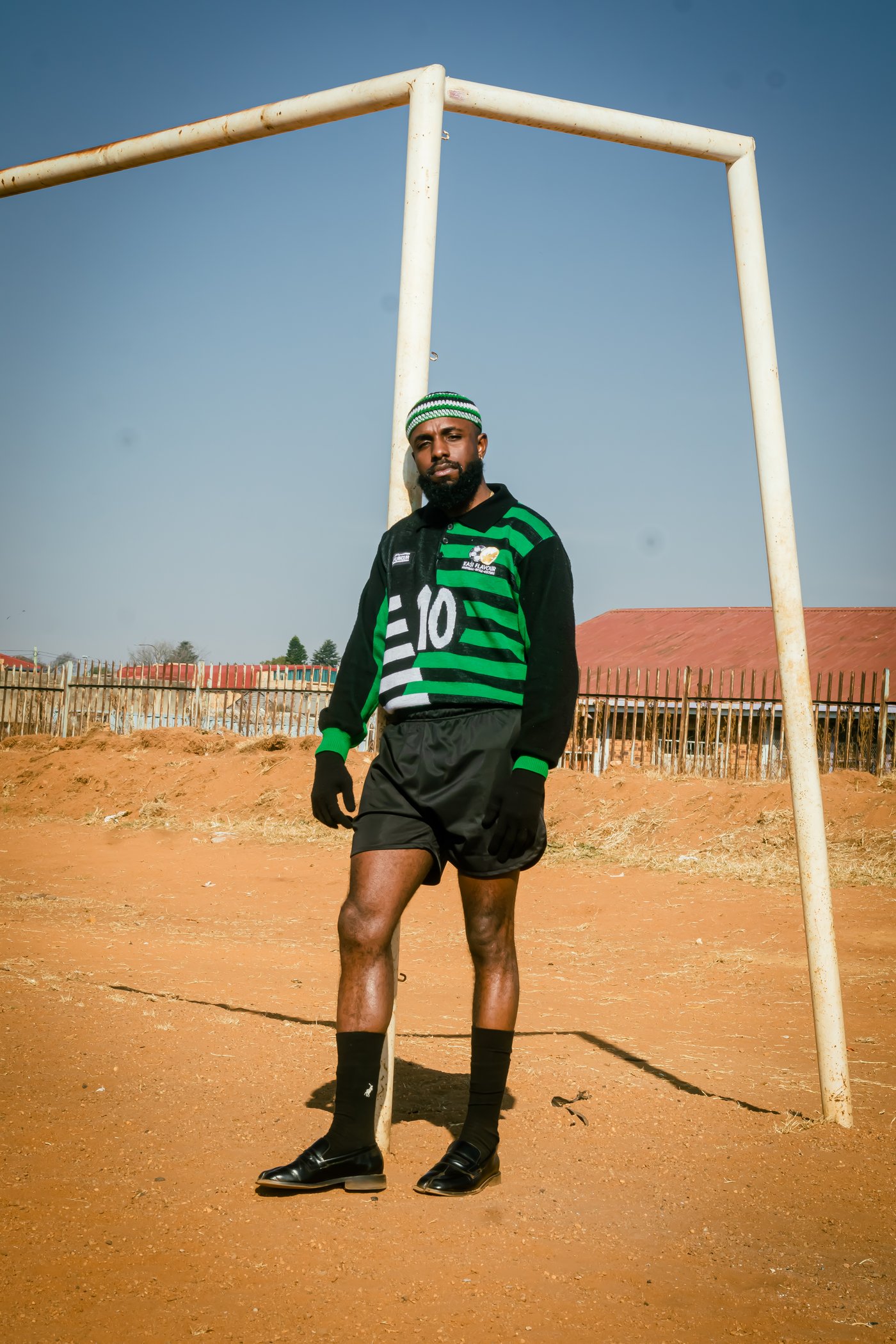 From Daily Click: man in green and black number 10 Kasi Flavour jersey standing at a goalpost